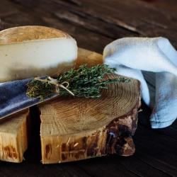 Cheese on wooden block chopping board